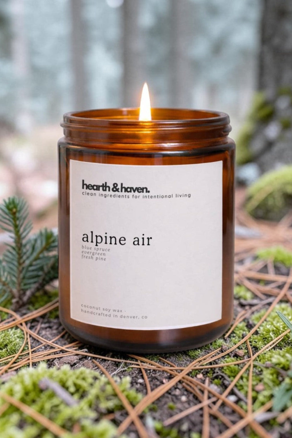 Hearth & Haven 'alpine air' candle in a forest setting
